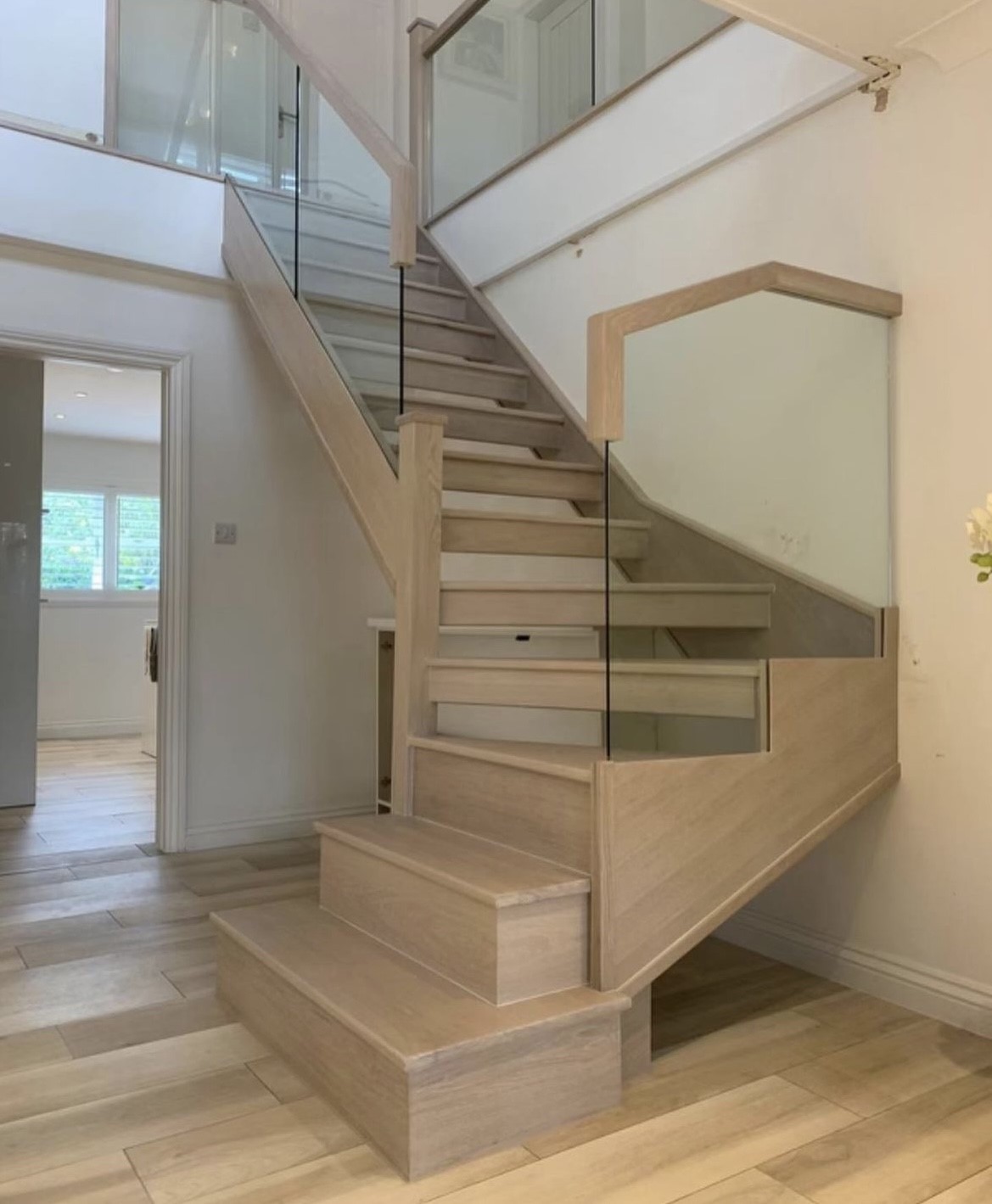 An example of a glass panel staircase renovation